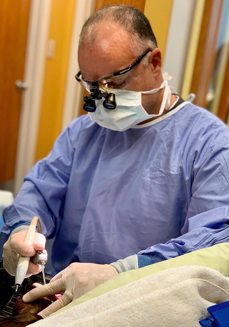 Doctor Performing Dental Cleaning Procedure On Patient